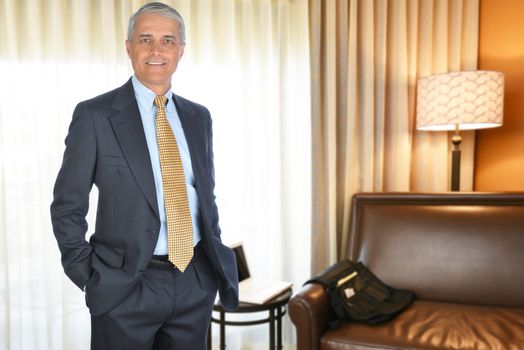 A mature businessman in a hotel room. Business travel concept.