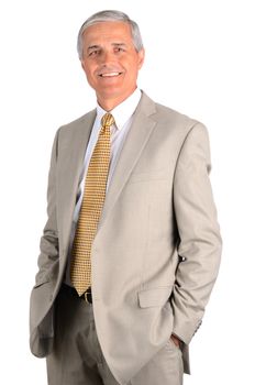 Smiling middle aged businessman with his hands in his pockets. Three quarters  over a white background.