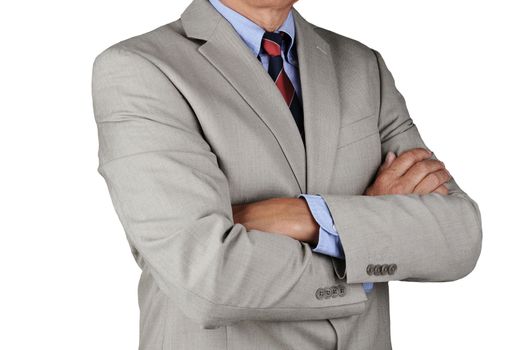 Closeup of a businessman wearing a light gray suit standing with his arms crossed. Horizontal format white, man is unrecognizable.