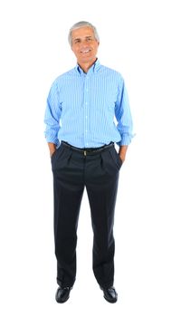 Smiling middle aged businessman standing with his hands in pockets. Full length over a white background.