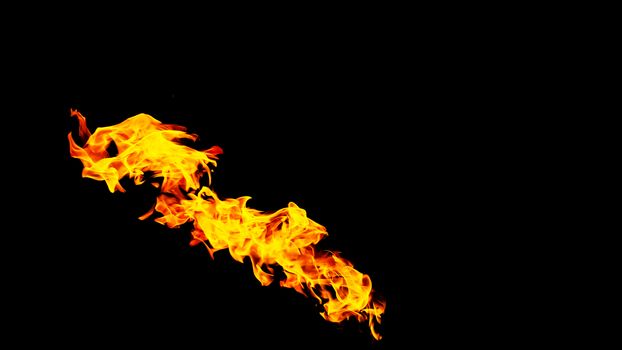 Fire flames on black background isolated. Burning gas or gasoline burns with fire and flames. Flaming burning sparks close-up, fire patterns. Infernal glow of fire in the dark with copy-space