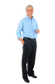 Smiling middle aged businessman standing with one hand in his pocket and the other holding his eye glasses. Full length over a white background.