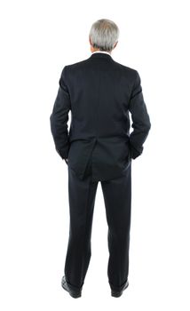 Standing middle aged businessman with both hands in his pockets. Full length shot of the mans back over a white background.