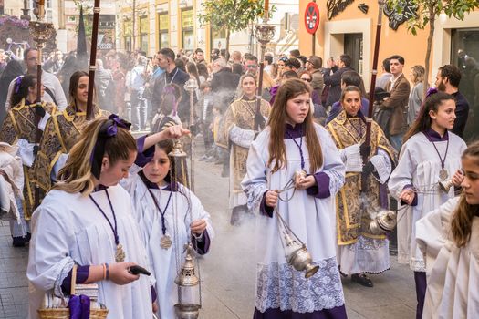 Malaga, Spain - March 26, 2018. Children participating in the procession in the Holy Week in a Spanish city