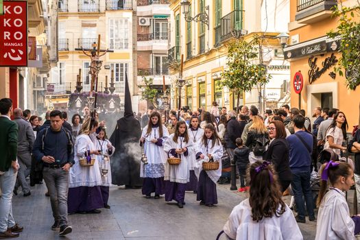 Malaga, Spain - March 26, 2018. Children participating in the procession in the Holy Week in a Spanish city