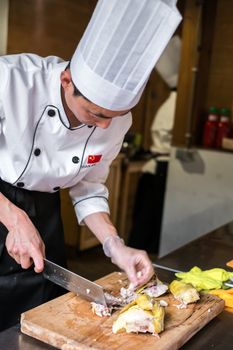 Sibiu City, Romania - 23 June 2019. Chinese cook arranges food on plates at the premiere of Lantern Festival from Astra museum in the Sibiu International Theatre Festival from Sibiu, Romania