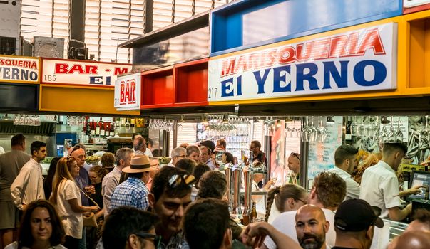 Malaga, Spain - May 16, 2018. people at the bar in the Ataranzanas Central Market, Malaga, Spain
