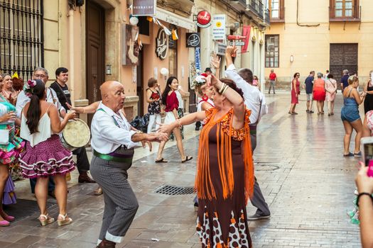 Malaga, Spain - August 12, 2018. People having fun on the street at the Feria de Malaga, an annual event that takes place in mid-August and is one of the largest fiestas in Spain