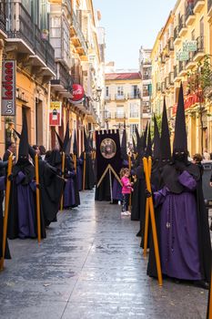 Malaga, Spain - March 26, 2018. People participating in the procession in the Holy Week in a Spanish city