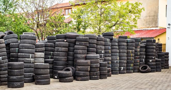 Sibiu, Romania - May 04, 2019. Used tire stacks in Workshop vulcanization yard