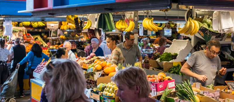 Malaga, Spain - May 12, 2018. Seller of dry fruits, and other Spanish specialities at the market of Ataranzanas Central Market, Malaga, Spain