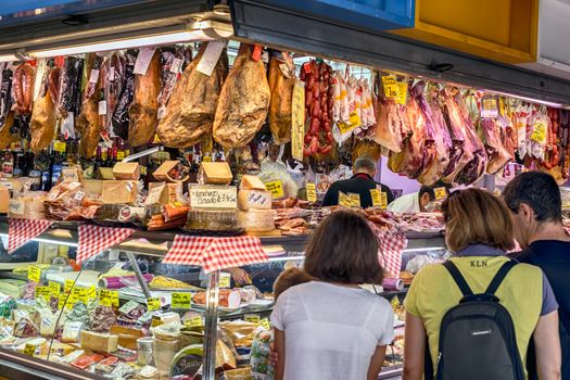 Malaga, Spain - August 04, 2018. Olive, Jamon iberico, dry fruits, sausages and other Spanish specialities at the market of Ataranzanas Central Market, Malaga, Spain
