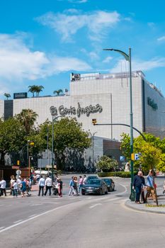 Malaga, Spain - May 26, 2018. Facade of the department store El Corte Ingles (The English Cut Mall) at shopping street and people