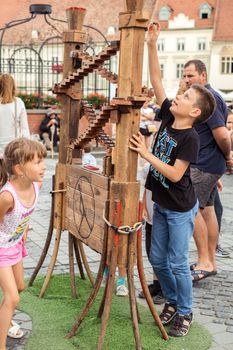 Sibiu City, Romania - 19 June 2019. children playing in The Strange Travel of Mr. Tonet from Spain, in the Big square, at the Sibiu International Theatre Festival from Sibiu, Romania.
