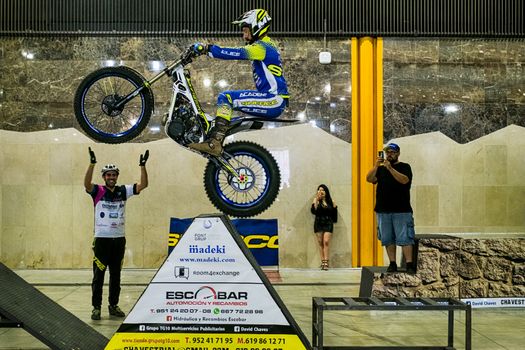 Malaga, Spain - May 20, 2018. Unknown man on trial motorcycle doing tricks during the Salón Moto & Bike Andalucía, Malaga city, Spain