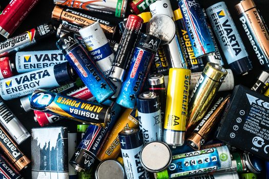 Sibiu, Romania - February 17, 2019. used disposable drain batteries of various size and color, top view