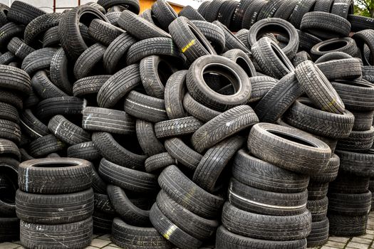 Sibiu, Romania - May 04, 2019. Used tire stacks in Workshop vulcanization yard