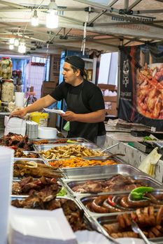 Sibiu city, Romania - September 23, 2018. Workers of a street fast food cafe serve customers at the Oktoberfest Festival in Sibiu city in Romania