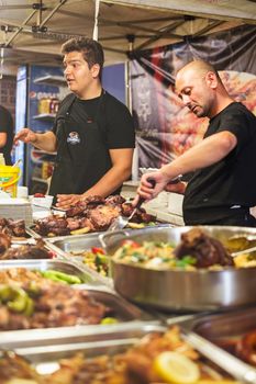 Sibiu city, Romania - September 21, 2018. Workers of a street fast food cafe serve customers at the Oktoberfest Festival in Sibiu city in Romania