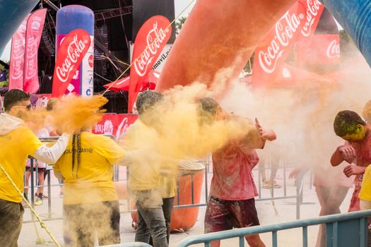 Malaga, Spain - February 18, 2018. Young people celebrate Holi color festival in Malaga, Spain.