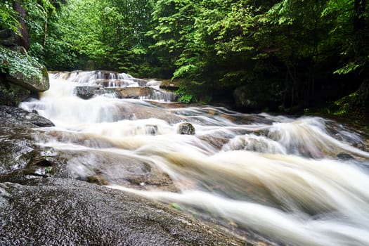 Rocks and boulders in the mountain stream in the forest in the Giant Mountains in Poland