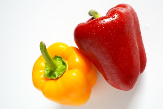 A red and yellow pepper against a plain white background