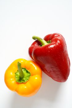 A red and yellow pepper against a plain white background