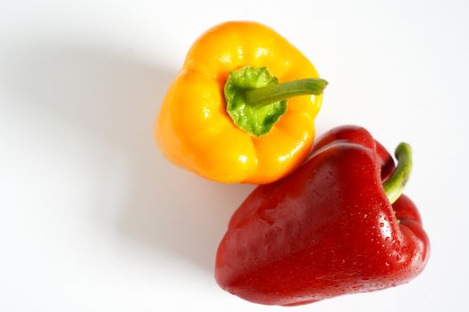 A red and yellow pepper against a plain white background