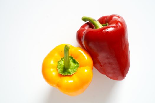 A red and yellow pepper against a plain white background