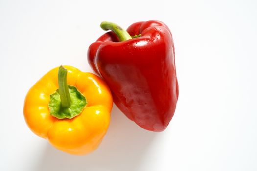 A red and yellow pepper against a plain white background