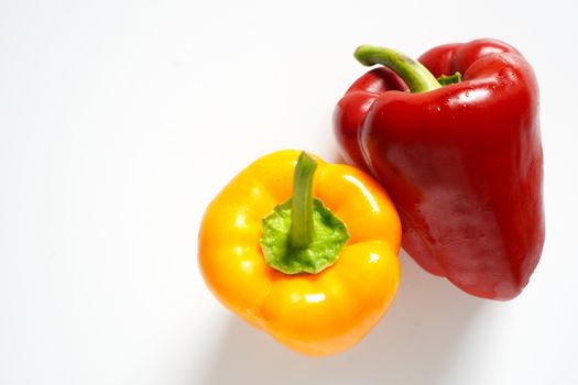 A red and yellow pepper against a plain white background