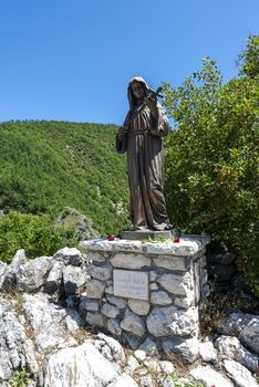 rocca porena,italy july 05 2020:monument of santa rita near the sanctuary of the rock in rocca porena where santa rita precava