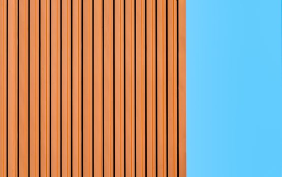 orange wall of a modern building on a background of blue sky simple architectural abstract background pattern