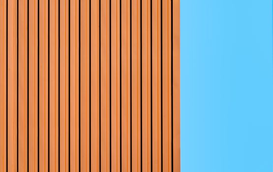 orange wall of a modern building on a background of blue sky simple architectural abstract background pattern