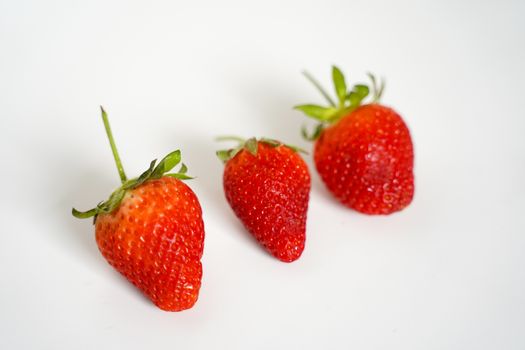 Three strawberries against a plain white background