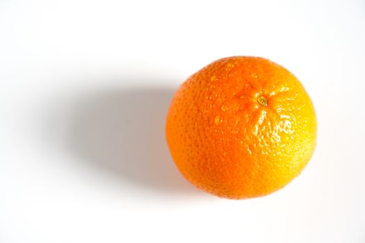 A whole orange against a plain white background