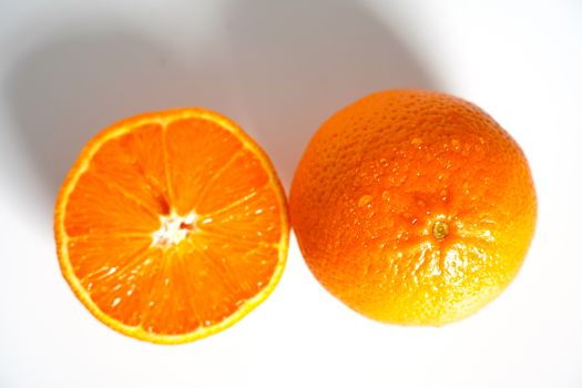 An orange sliced in half against a plain white background