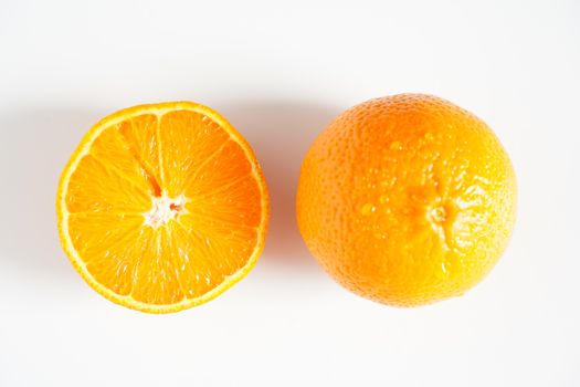 An orange sliced in half against a plain white background