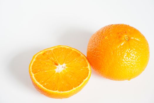 An orange sliced in half against a plain white background