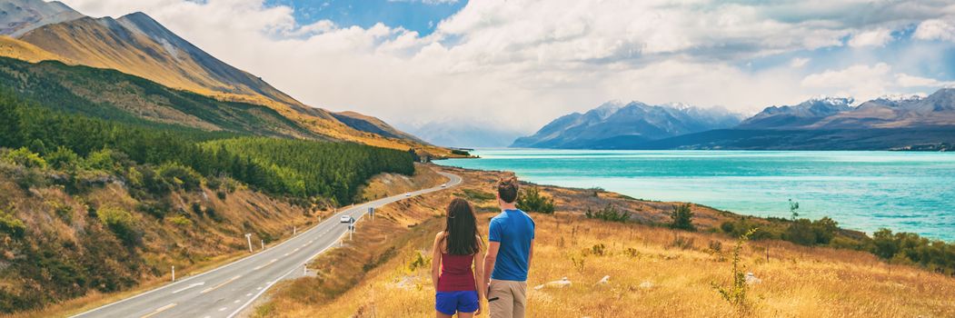 New Zealand travel people looking at Mount Cook Aoraki far in the landscape. Couple tourists walking at Peter's lookout, banner panorama copy space on background.