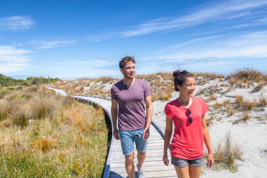 New Zealand. People hiking in beach nature landscape in Ship Creek on West Coast of New Zealand. Tourist couple sightseeing tramping on South Island of New Zealand.