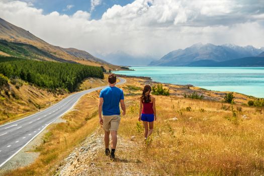 New Zealand travel nature couple tourists looking at view of Aoraki/Mount Cook at Peter's lookout, famous tourist destination.