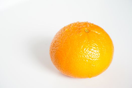 A whole orange against a plain white background