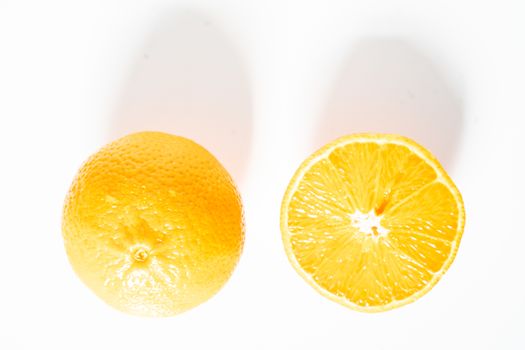 An orange sliced in half against a plain white background