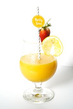 An orange cocktail drink with a party straw against a plain white background