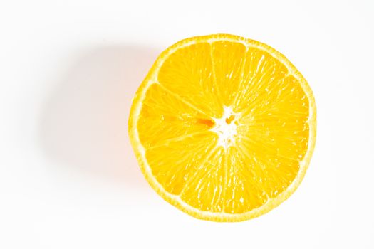 An orange sliced in half against a plain white background