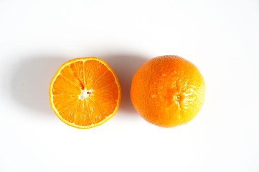 An orange sliced in half against a plain white background