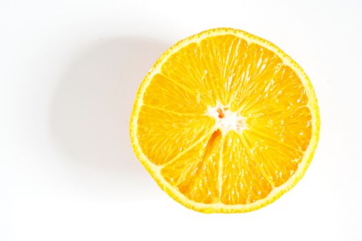 An orange sliced in half against a plain white background