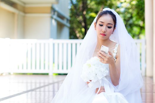 bride talking on cell phone in wedding dress