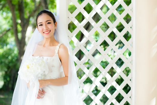 Asian bride at outdoor in a morning.